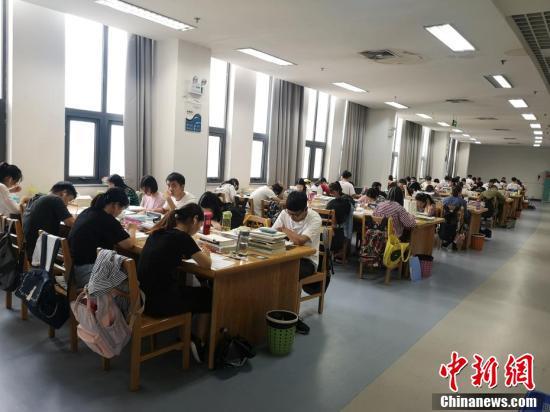 进到图书馆后,大学们认真学习.