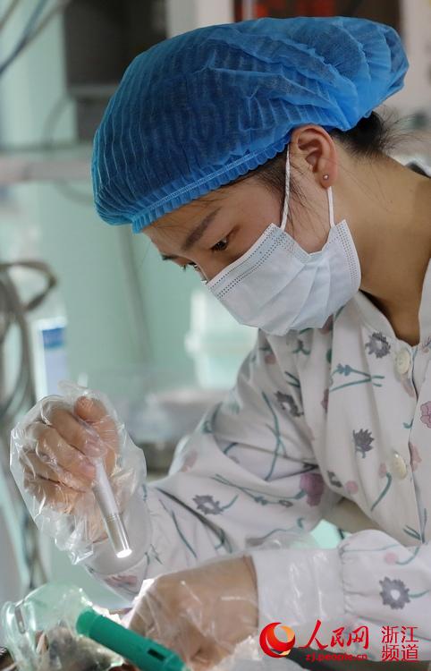 90后护士俞佳欣在观察患者的瞳孔状况.