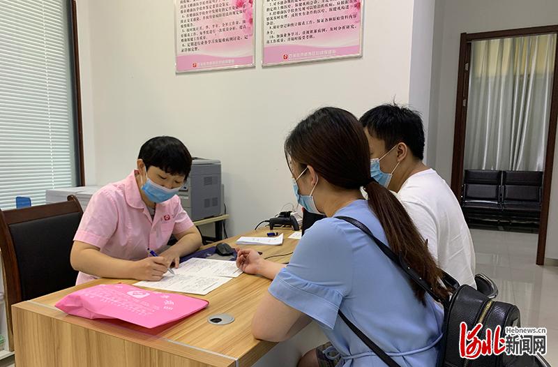 6月9日，在石家庄桥西区婚姻登记处的区妇幼保健站婚检便民点，医护人员对前来领取结婚证的一对准新人，边讲解免费婚检的相关内容，边量血压。河北日报记者张淑会摄