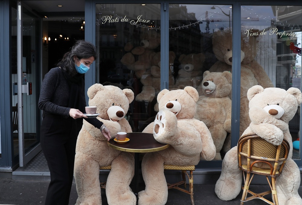 当地时间2021年3月26日,法国巴黎一家咖啡馆的主人为超大号泰迪熊上咖啡。当天,一群憨态可掬的超大号泰迪熊“占领”了没有顾客的餐馆、咖啡馆,四仰八叉“享受”咖啡、香槟和暖阳。据报道,这些泰迪熊均由在巴黎经营书店的菲利普·拉布雷尔提供。他2018年10月开始把这些毛绒玩具借给很多地方摆放,新冠疫情以来也没有间断,给路过的人们带来笑容。拉布雷尔说,他在去年疫情暴发后买了更多泰迪熊,用于装点市容。受新冠疫情影响,法国的餐馆、咖啡馆、酒吧等公共场所自去年10月底一直关闭至今,只能提供外卖服务。