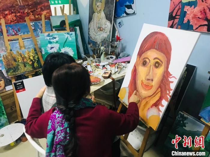 徐渝江陪伴谢昕欣画画。 岳依桐 摄