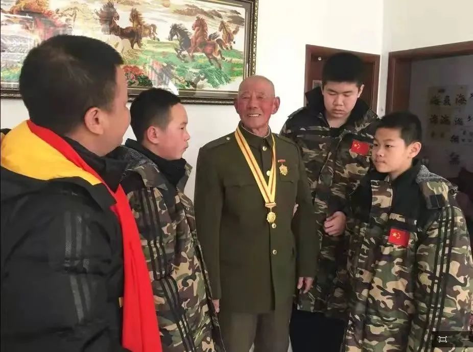 学生们正在听董存瑞当年的战友，92岁的李德富老战士讲战斗故事 （受访者供图）