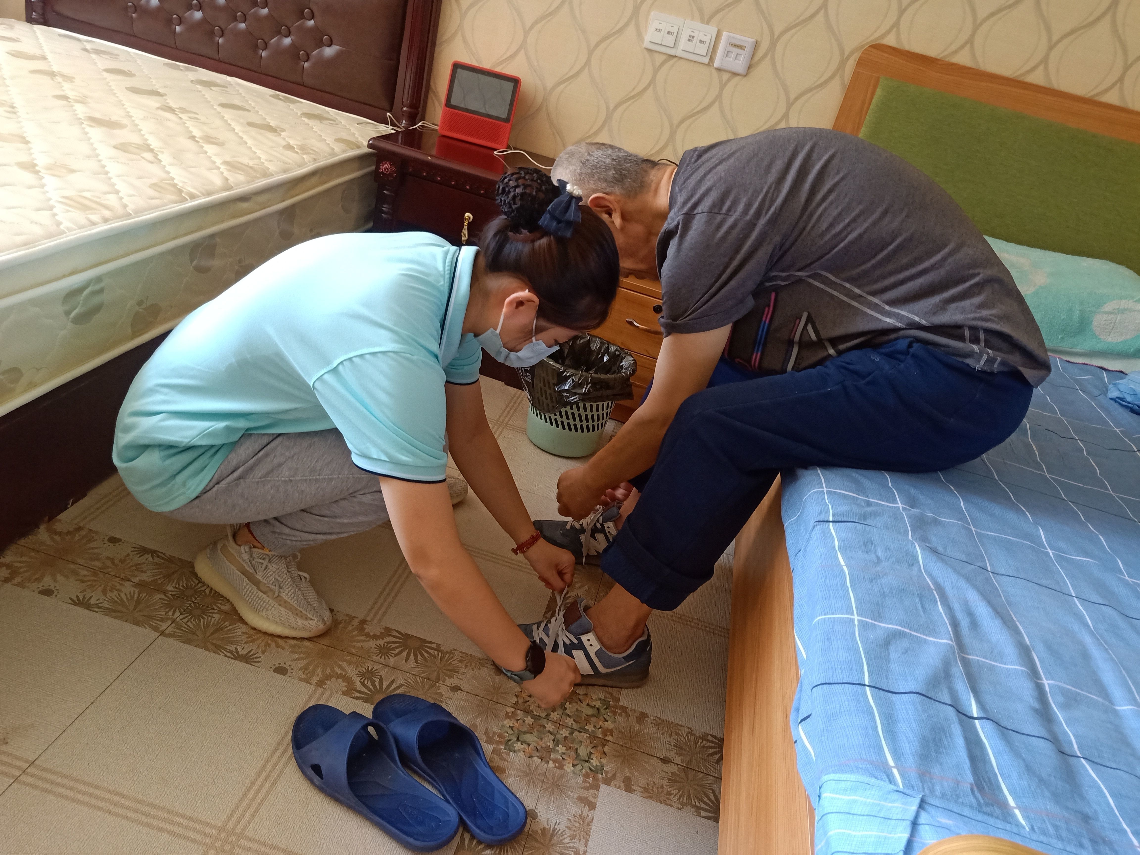 张鑫帮老人系鞋带. 受访者供图