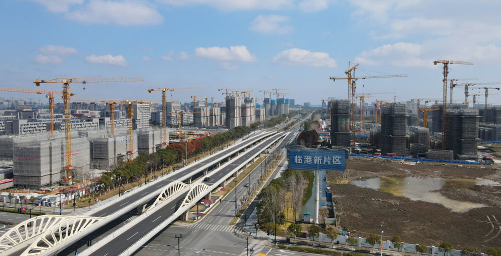 中国(上海)自由贸易试验区临港新片区申港大道两侧塔吊林立(2022年2月10日摄,无人机照片)。新华社记者 方喆 摄