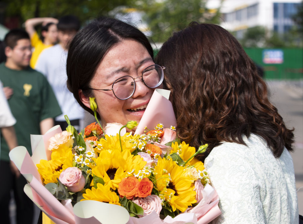 ↑6月9日，在江苏省泰州市海陵区田家炳实验中学考点，一名考生在考试结束后与家长拥抱在一起。新华社发（汤德宏 摄）