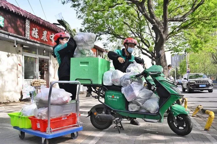▲4月26日上午,叮咚买菜(十里堡店)骑手装货。
