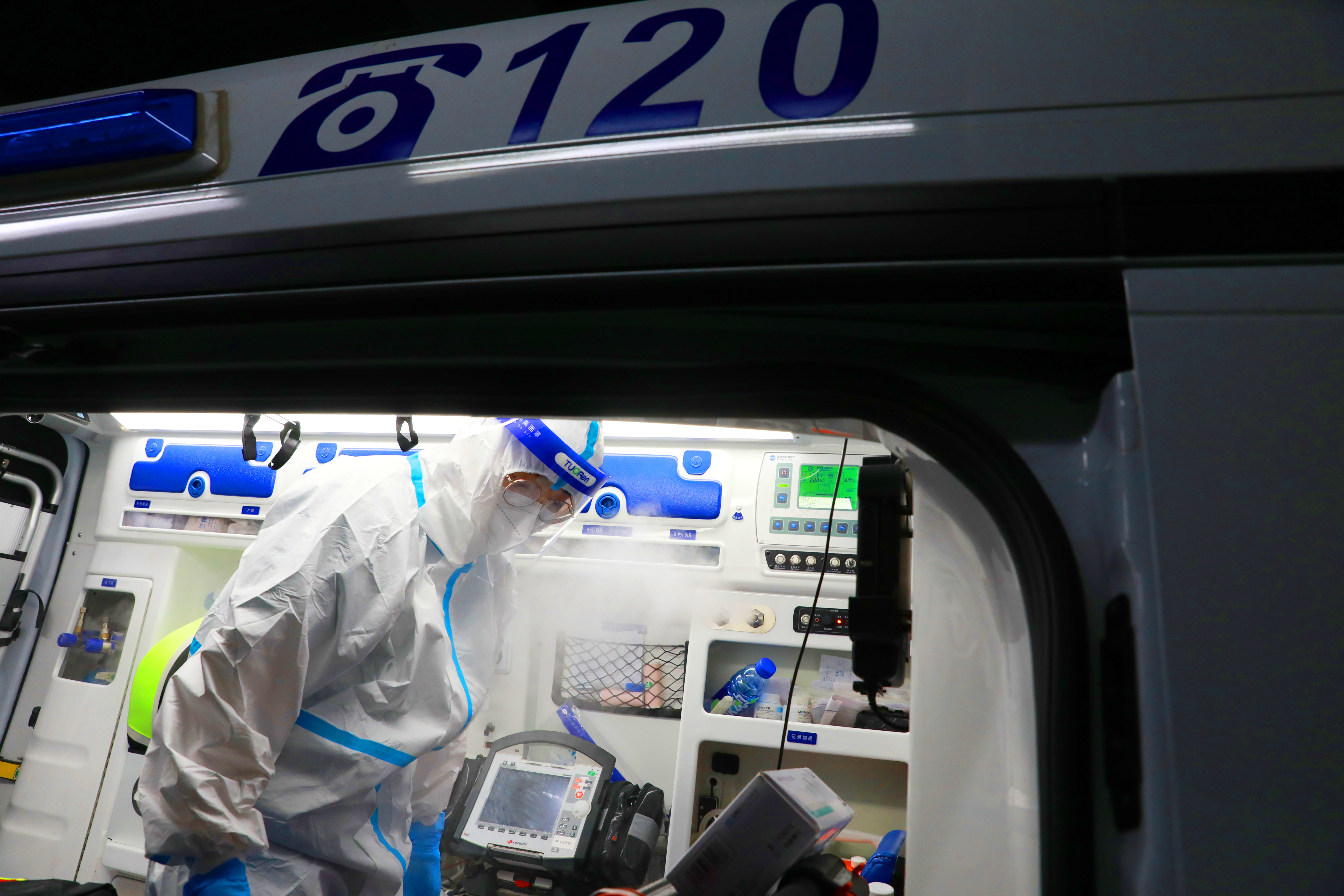 4月20日晚,上海市医疗急救中心随车医生卢恒辉在一处消杀站点对急救车进行消毒。中国日报 记者朱兴鑫 摄