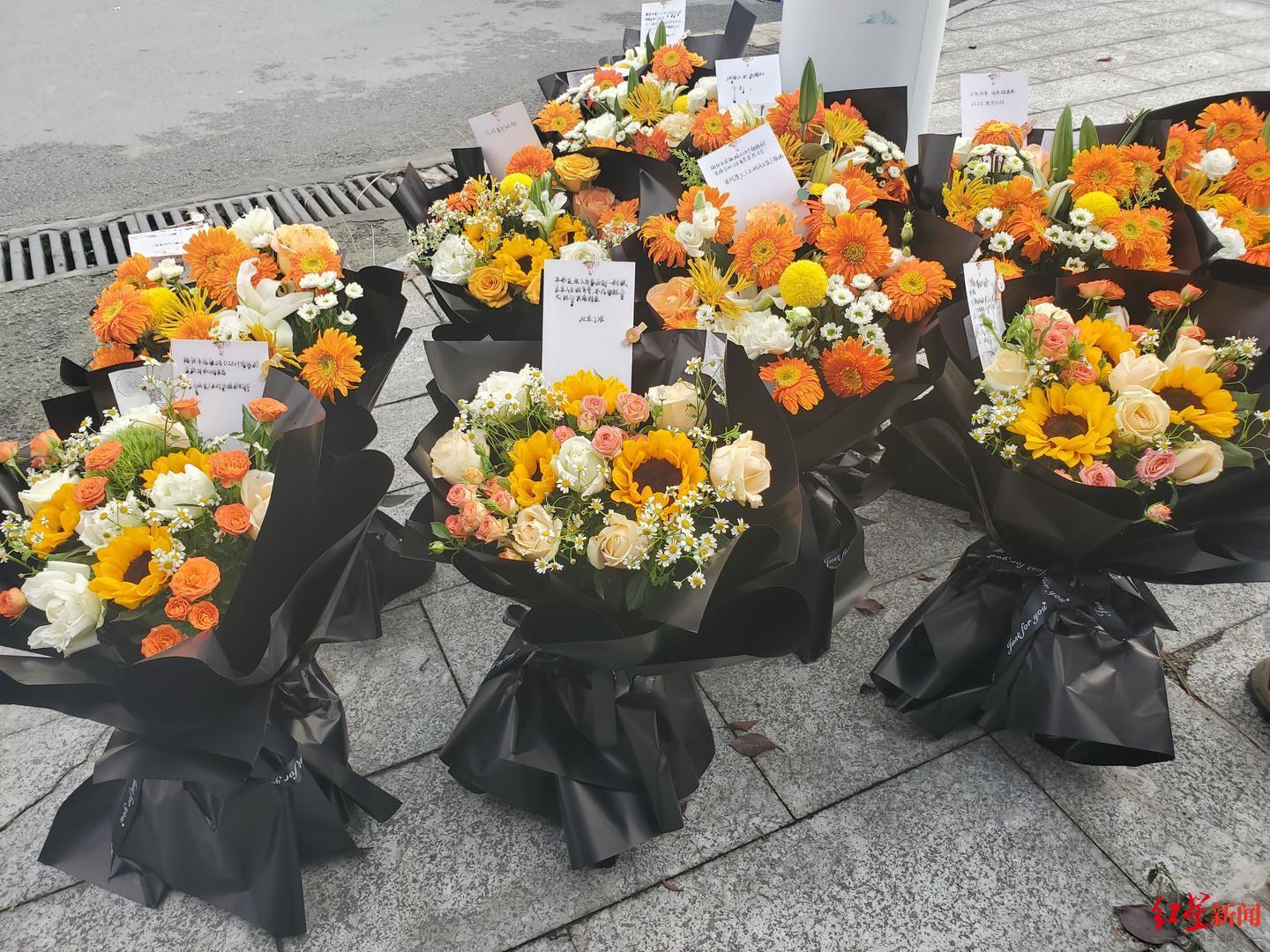 ▲榕江站外的一处路灯下，摆放着10束鲜花，悼念司机杨勇