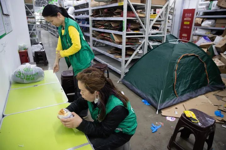 4月12日，在美团买菜上海逸仙路站，工作人员起床后吃早餐。新华社记者 金立旺 摄