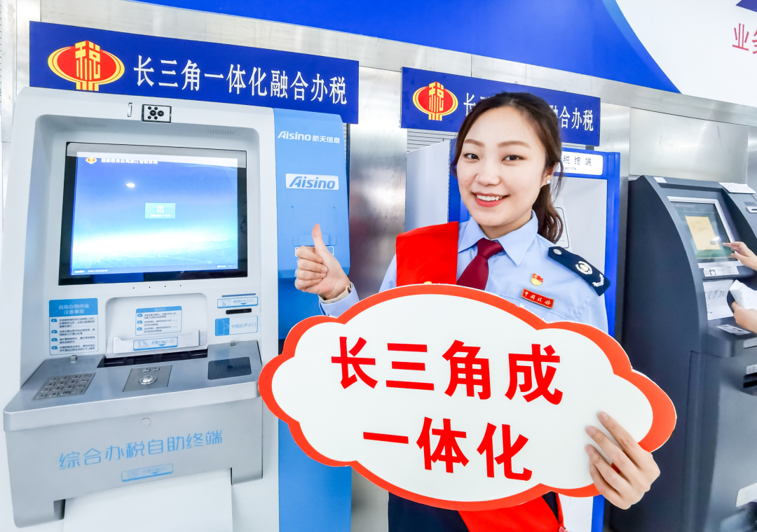 图为国家税务总局青浦区税务局税务干部向广大纳税人缴费人推荐长三角一体化融合办税Arm机。