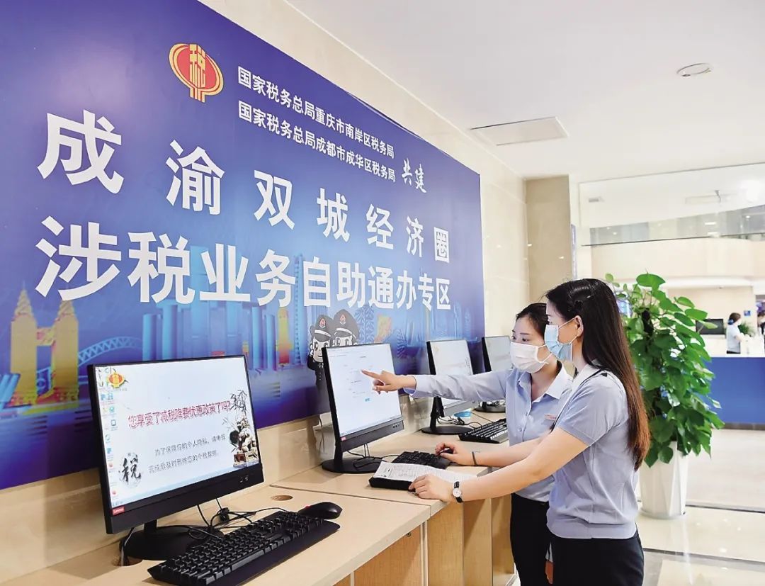 图为税务干部指导纳税人在成渝双城经济圈涉税业务自助通办专区办理业务。何国刚/摄
