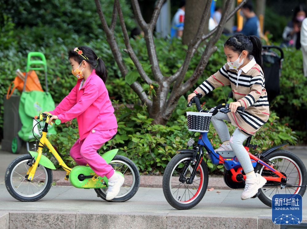 5月17日，在上海市松江区，小朋友们在骑自行车。新华社记者 刘颖 摄