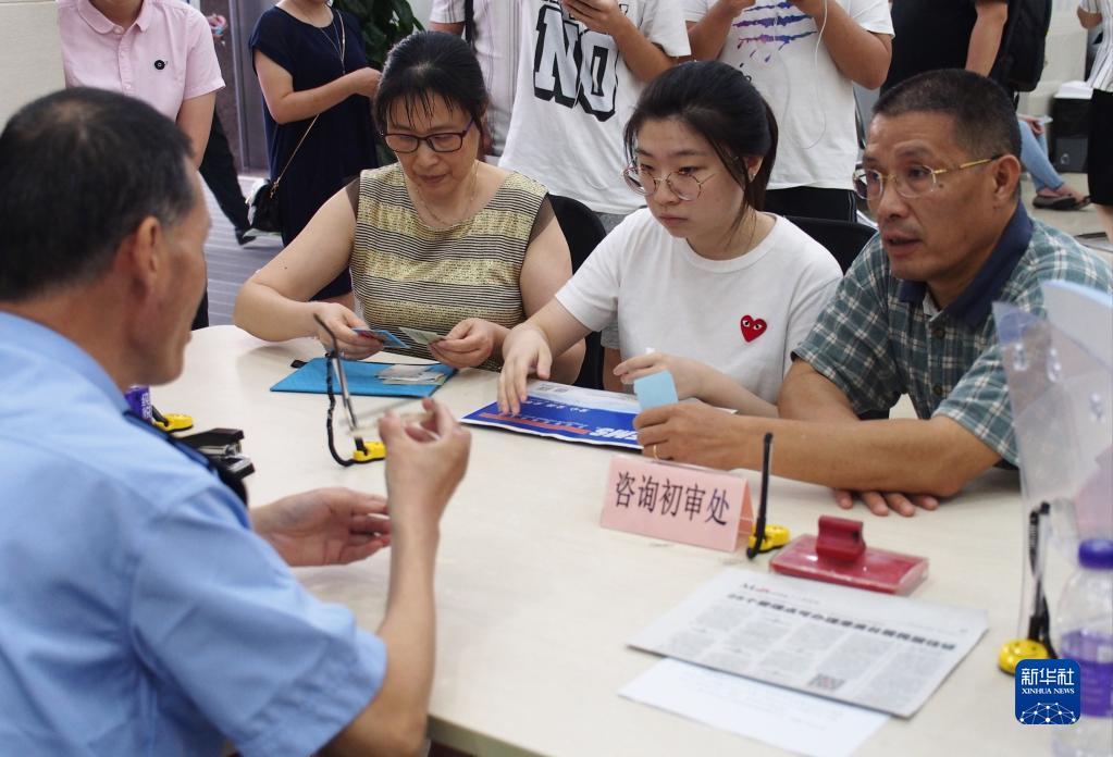 在上海市闵行区证照办理中心，民警在解答有关为香港居民办理居住证的手续问题（2018年9月1日摄）。新华社记者 任珑 摄