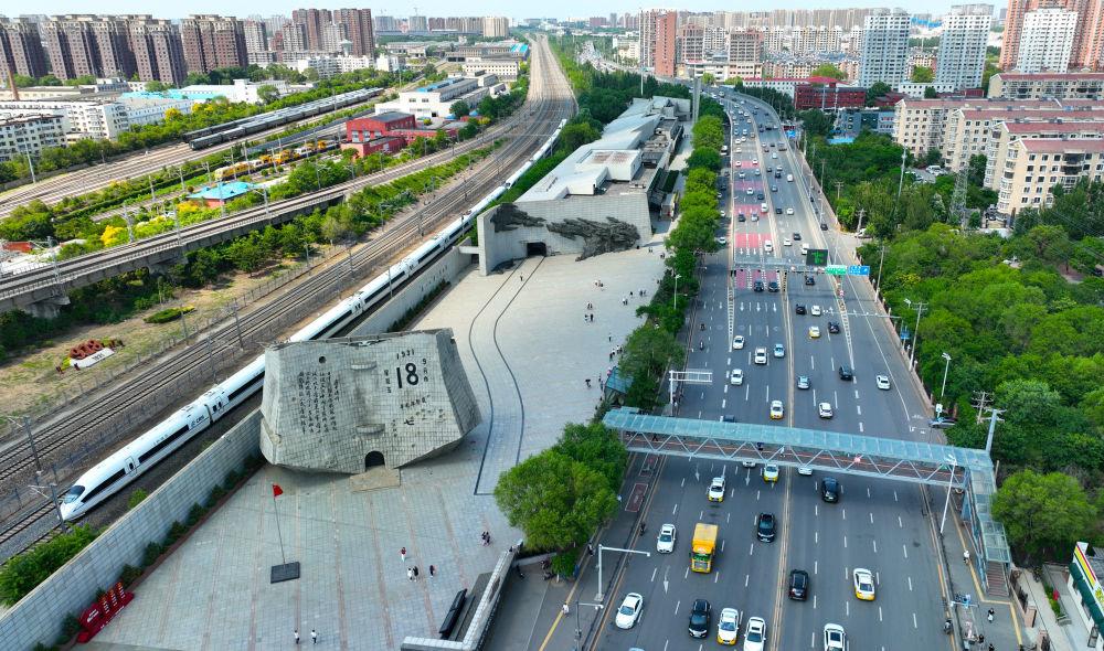 2023年6月6日，一辆高铁列车在沈阳“九一八”历史博物馆旁经过。新华社记者杨青 摄