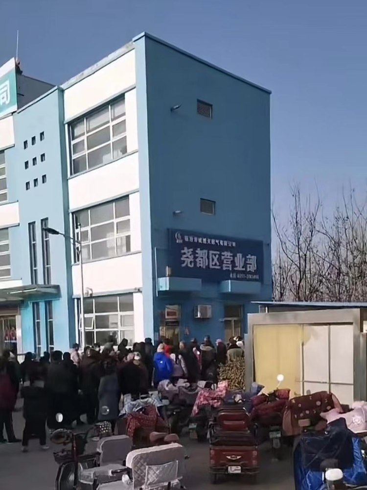 12月6日下午,城燃公司尧都区营业部门前排起长队。图片来源/网络视频截图