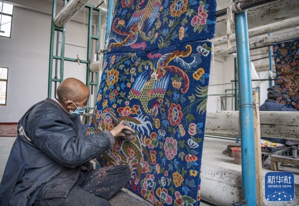 ↑在江孜县地毯厂，工人对卡垫进行修剪（3月19日摄）。
