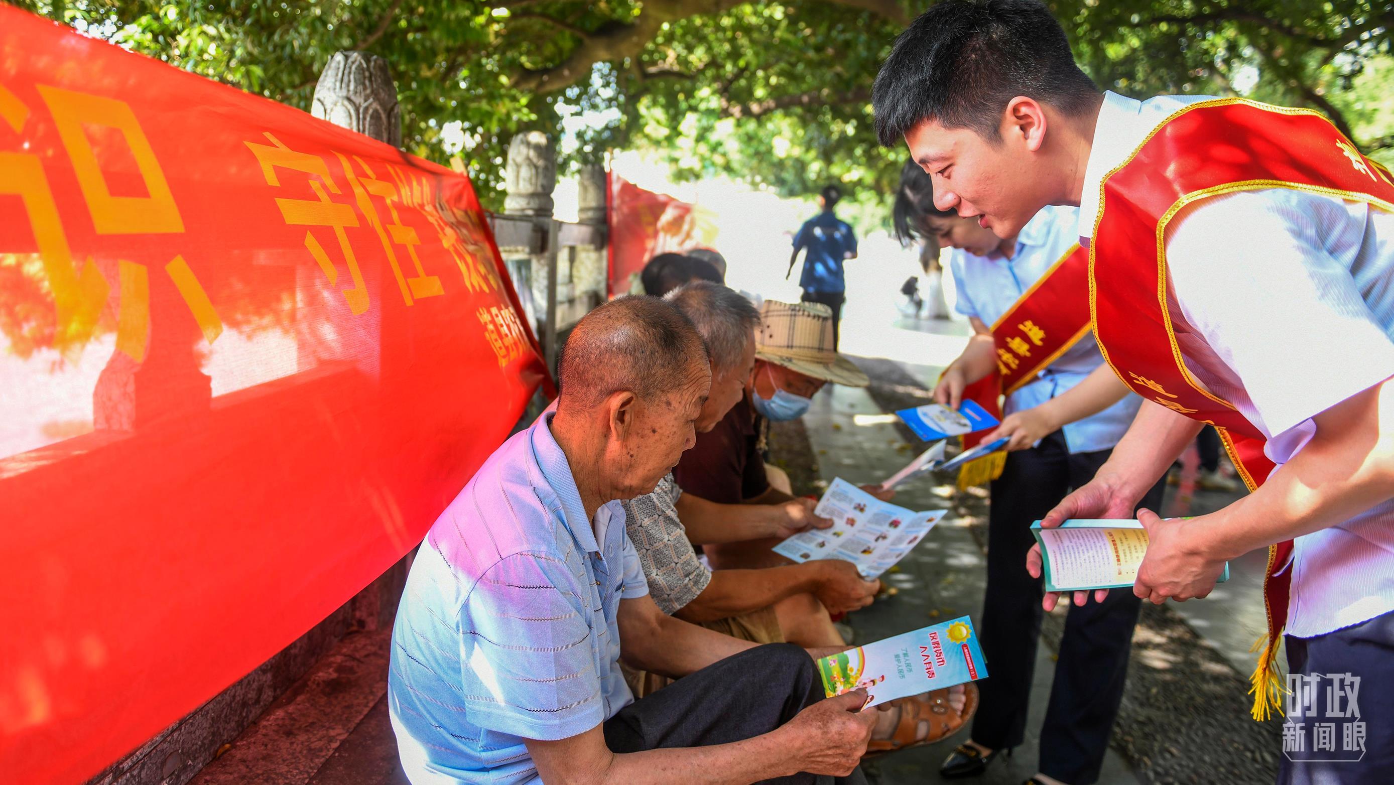 △银行工作人员正在向群众普及金融和防范非法集资等有关知识。（图/视觉中国）