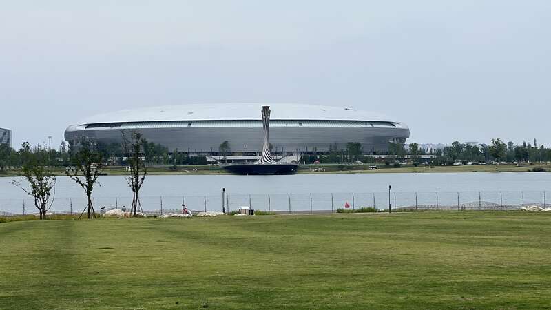 承担成都大运会开幕式的东安湖主体育场和火炬塔与主媒体中心隔湖相望。汪龙华/摄