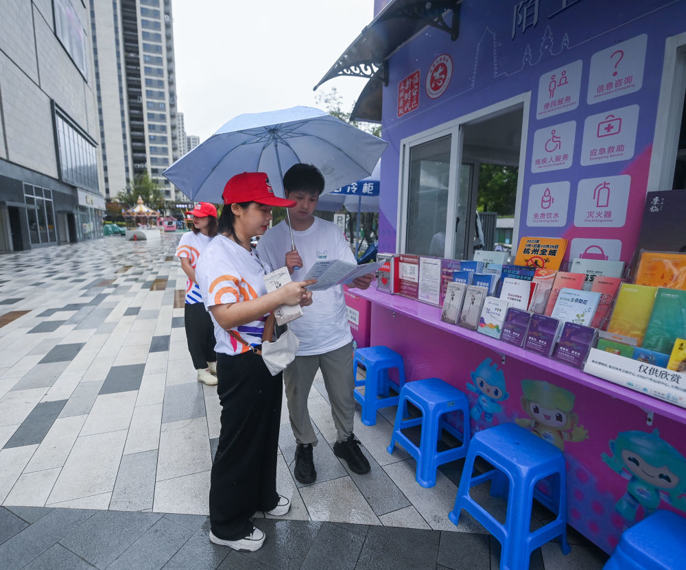 9月15日，志愿者在临安体育文化会展中心体育馆旁的亚运城市志愿服务文明驿站工作。 新华社记者 徐昱 摄
