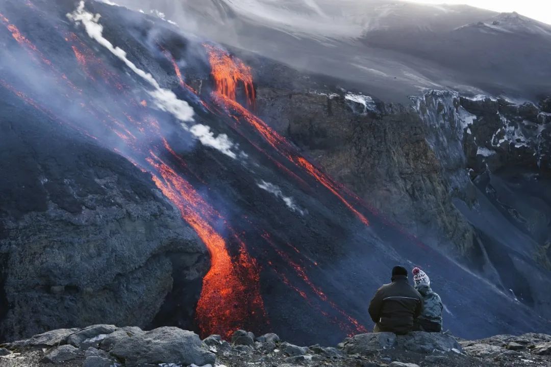 登山者观赏火山美景 / 视觉中国