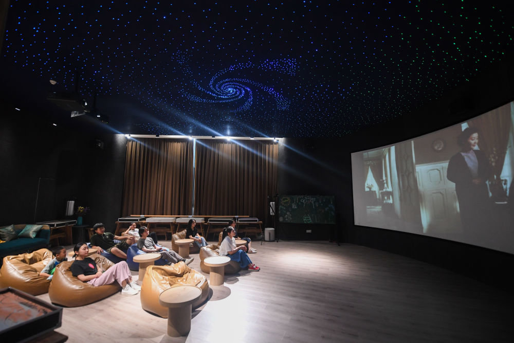 居民在位于浙江省杭州市富阳区银湖街道硅谷社区的"合之舍"书房的影视