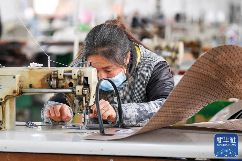 1月28日，工人在贵州余庆经济开发区内一家箱包企业车间内忙碌。新华社发（贺春雨 摄）