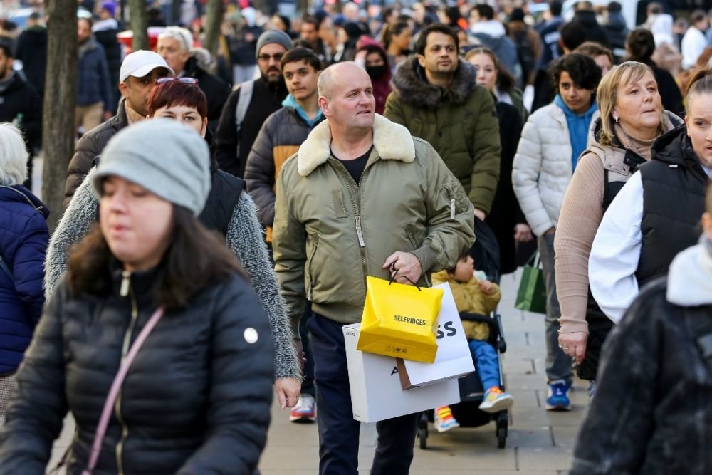 2022年12月26日，人们手提购物袋走在英国伦敦牛津街上。新华社发（迪南德拉·哈里亚摄）