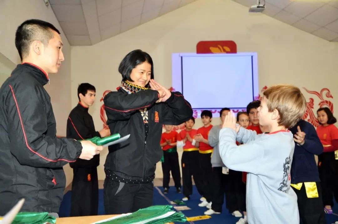 ·小学员参加武术俱乐部的等级考试后，向陈敏行抱拳礼。