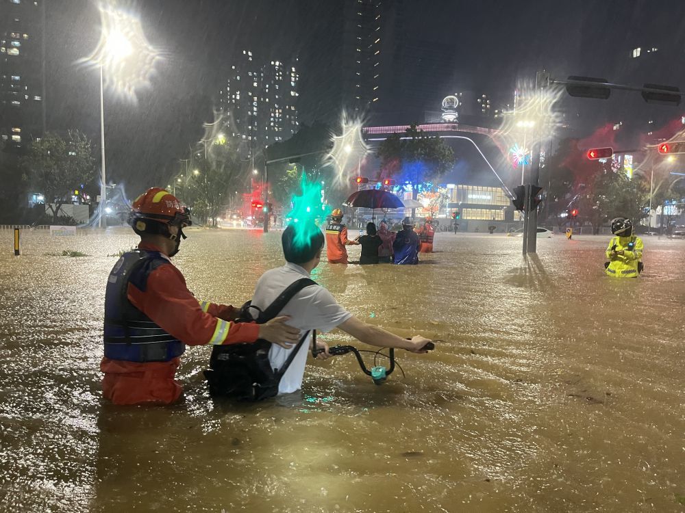 9月7日，深圳市消防救援支队消防救援人员在深圳市龙岗区愉龙路积水严重区域帮助市民转移。新华社发（韦伟家 摄）