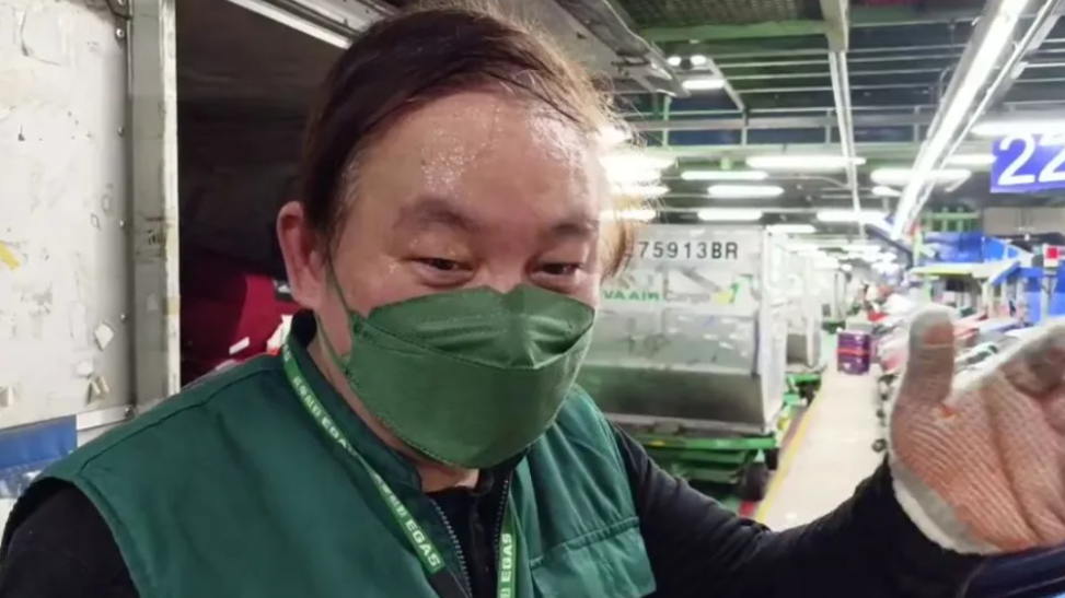 长荣航勤董事长陈有玉1月2日上阵搬行李。图自TVBS新闻网