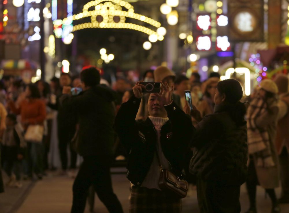 11月16日晚,游人在电影小镇内游览拍照。新华社记者 戴翘楚 摄