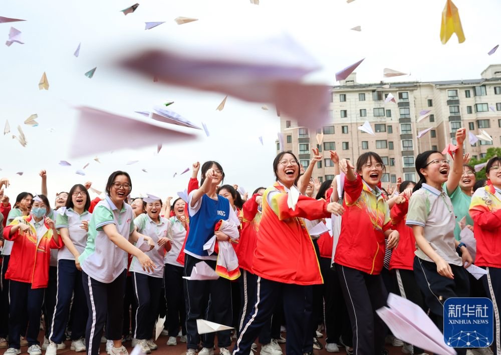 ↑6月2日，湖北襄阳五中高三学生在操场上放飞写有自己心愿的纸飞机。