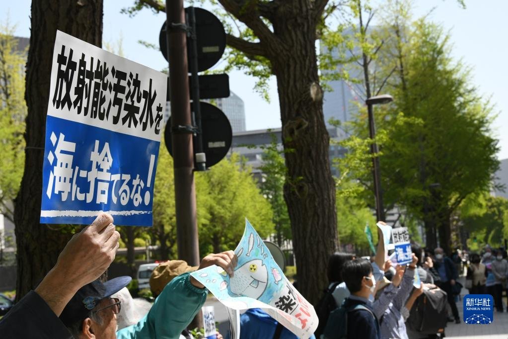 4月13日，在日本东京，民众手举标语在日本国会众议院第二议员会馆前参加集会抗议。新华社记者 岳晨星 摄