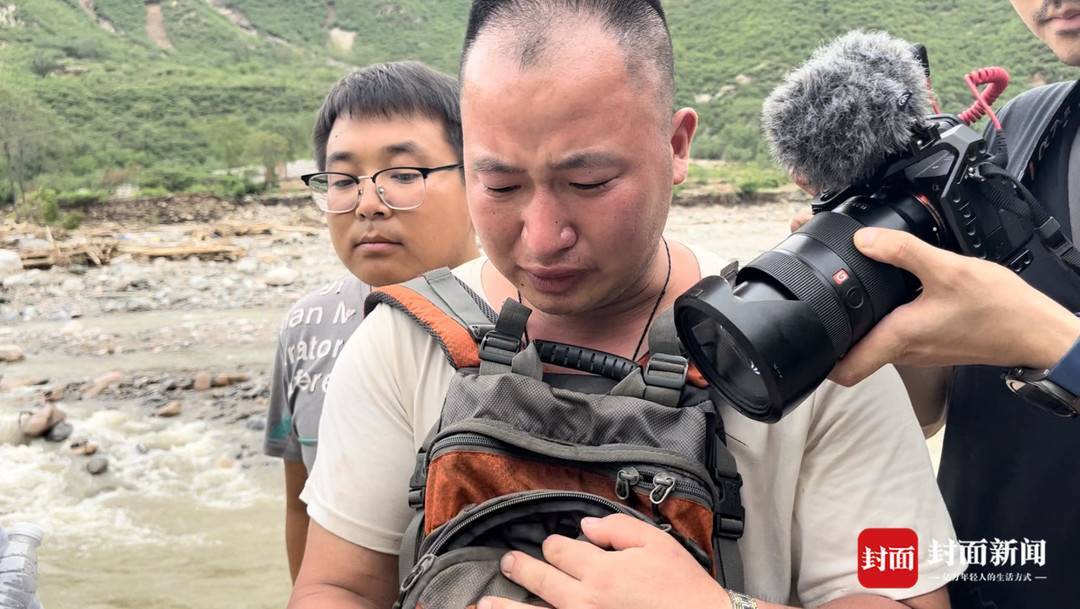 8月5日，李金明给记者看手机里女儿的照片。 拍摄：郝莹