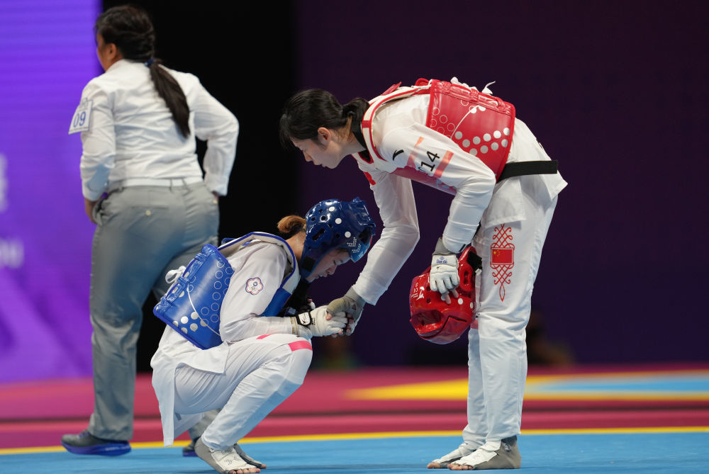 9月27日，宋洁（右）与张芮恩在跆拳道女子67公斤级1/4决赛后握手致意。