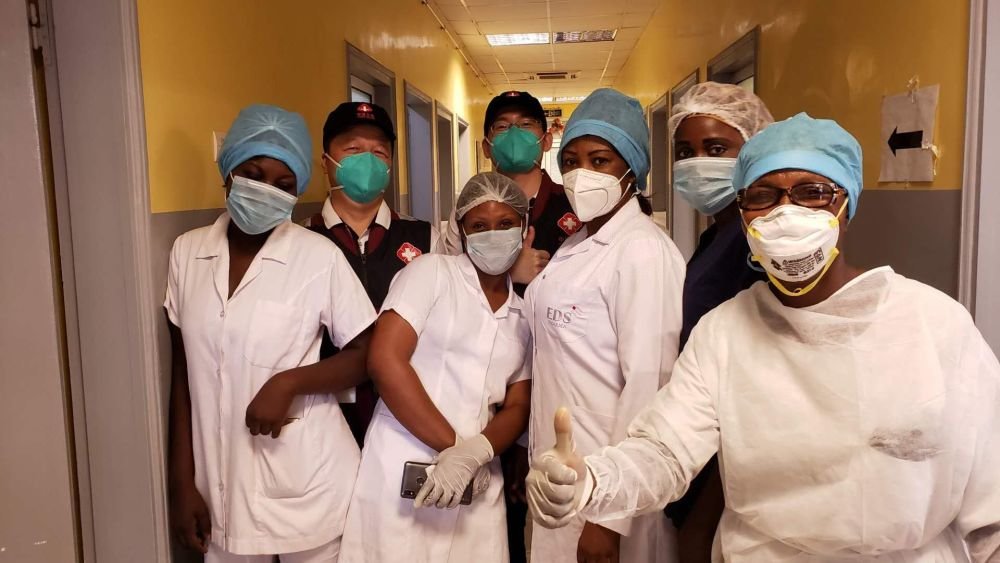 2020年5月26日，中国抗疫医疗专家组在刚果（布）首都布拉柴维尔指导新冠肺炎病房建设时，与当地一线医务人员合影。新华社发