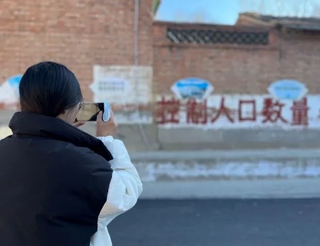 2月8日,河北省廊坊市三河市燕郊镇翟家庄村墙壁上 ,有“控制人口数量”等宣传标语。徐婷婷摄
