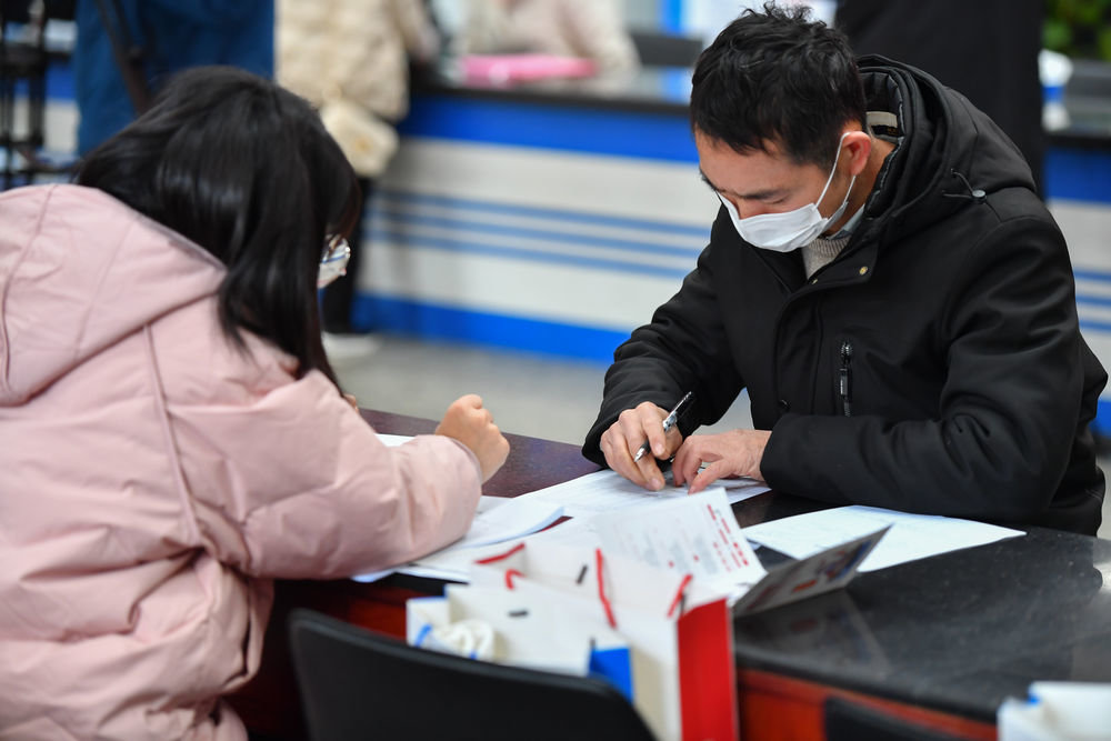 1月28日,在湖南省长沙市人力资源市场,求职者(右)在填写应聘信息表。新华社记者 陈泽国 摄