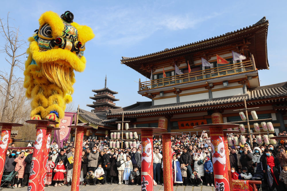 ↑1月25日，游客在湖北省襄阳市唐城春节庙会观看舞狮表演。新华社发（杨东摄）