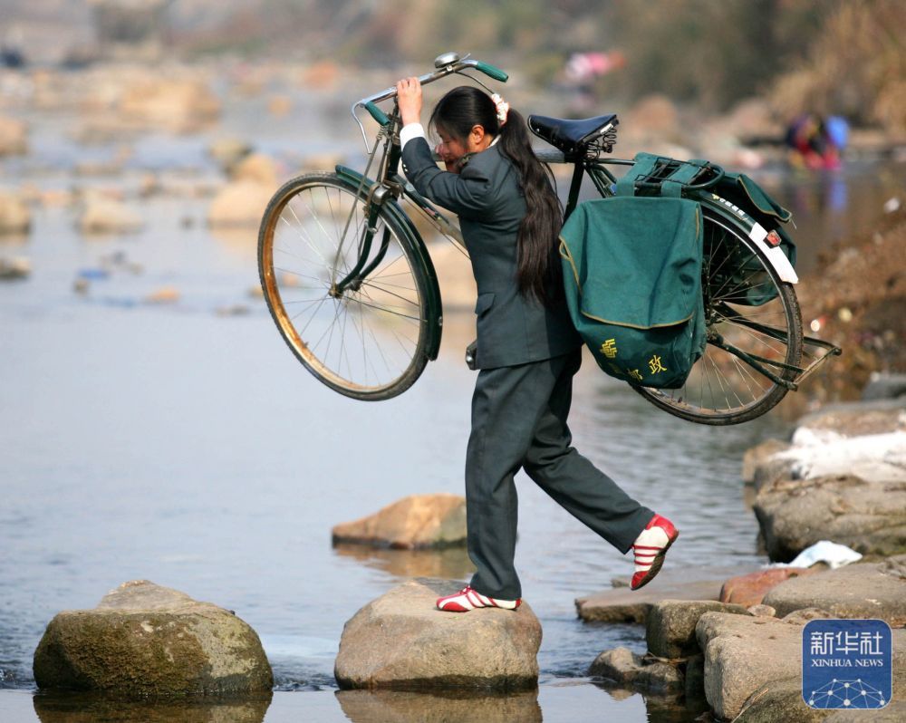 江西省铅山县陈坊乡，罗细英走在山间邮路上（2007年1月6日摄）。新华社记者陈春园摄