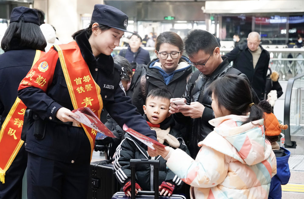 2024年1月26日，北京铁路公安局民警在北京西站发放出行安全宣传单。新华社记者 李欣 摄