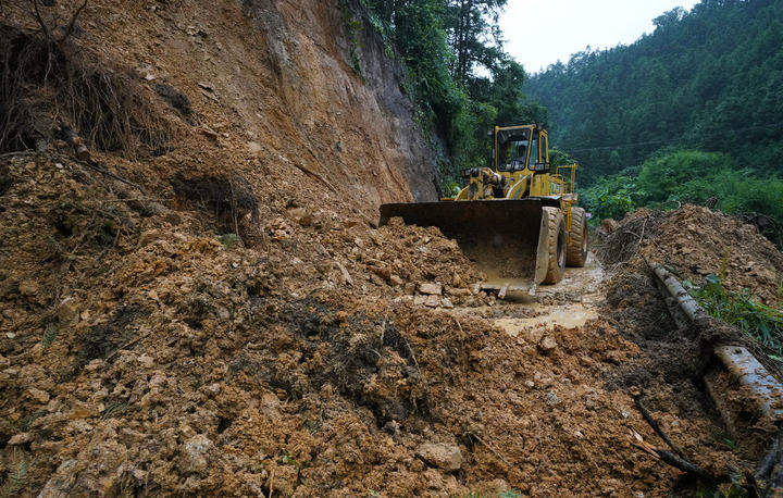 6月18日，在广西融水苗族自治县融水镇新安村，一台推土机在清理塌方路段。新华社发（龙林智摄）
