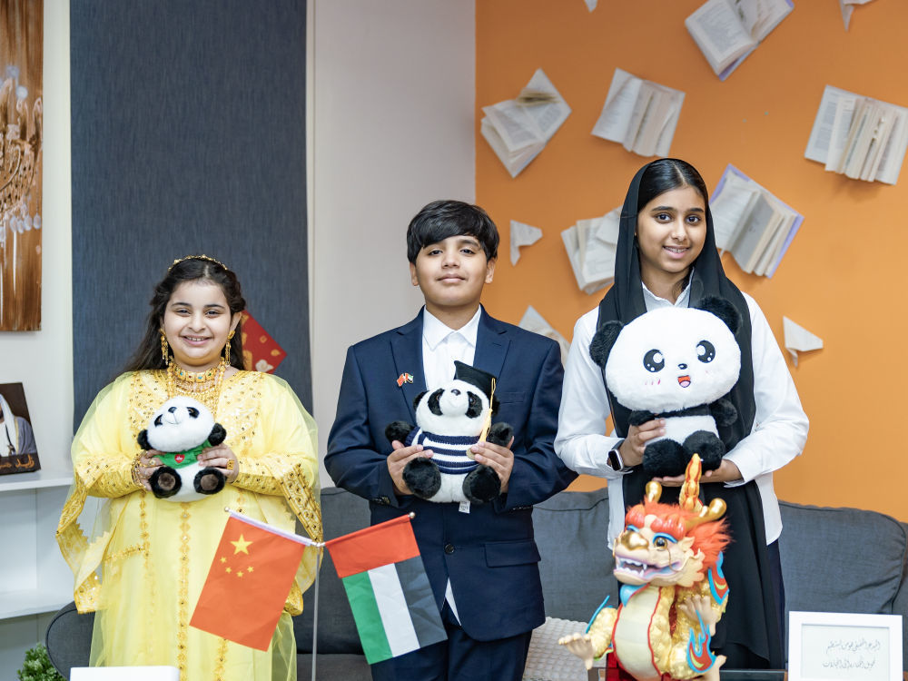 5月27日，阿联酋哈姆丹学校三名学生展示他们喜欢的大熊猫玩偶。