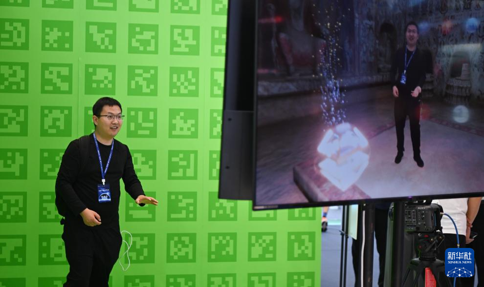 在文博会腾讯展台，观众体验“臻彩云境”实时视频特效合成技术（5月23日摄）。