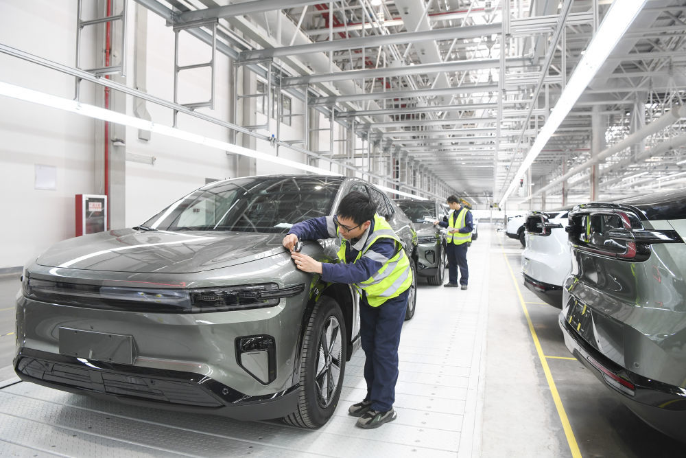 2024年3月14日,工作人员在长安汽车重庆渝北新工厂总装车间进行整车下线前的检查。新华社记者 王全超 摄