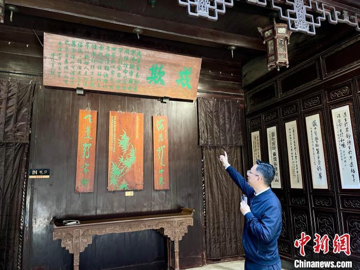 4月24日，陈蕴涵向记者介绍胡庆余堂“戒欺”牌匾。张斌 摄