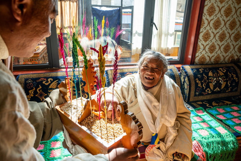 在位于西藏拉萨市当雄县公塘乡甲根村的家中，斯曲旺姆正在吃“切玛”（2月10日摄）。新华社记者 丁增尼达 摄