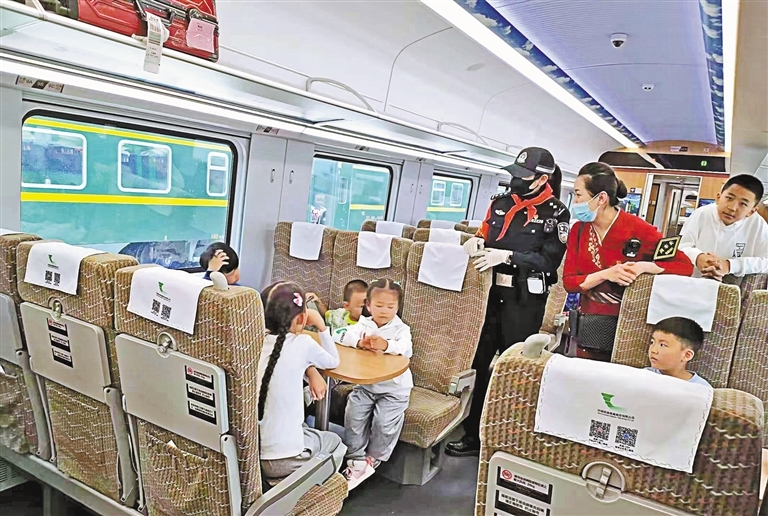 列车乘务员与乘客热情互动。记者 王莉 摄