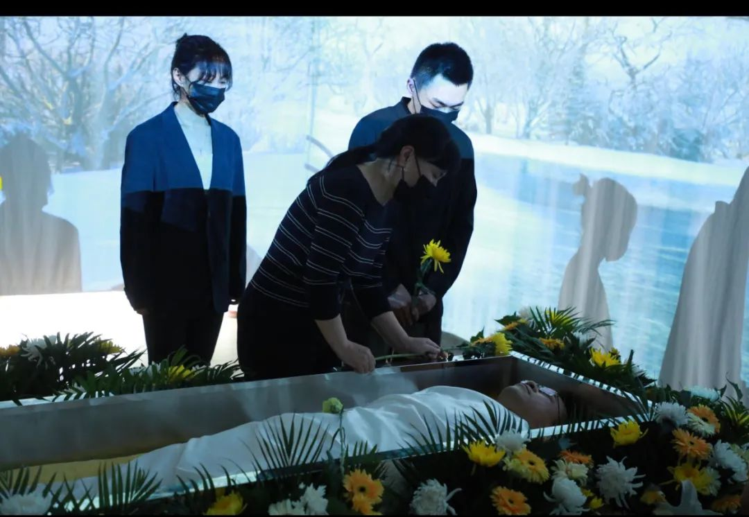 生前葬礼上,路桂军躺在棺木里,家属挽别(图源:中国新闻周刊)