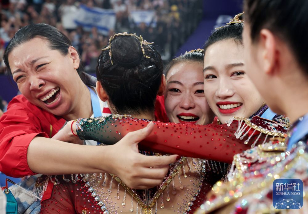 ↑2024年8月10日，中国队教练孙丹（左一）在比赛后与夺得巴黎奥运会艺术体操项目集体全能金牌的队员庆祝。这是中国队在该项目获得的首枚奥运金牌。新华社记者 许雅楠 摄